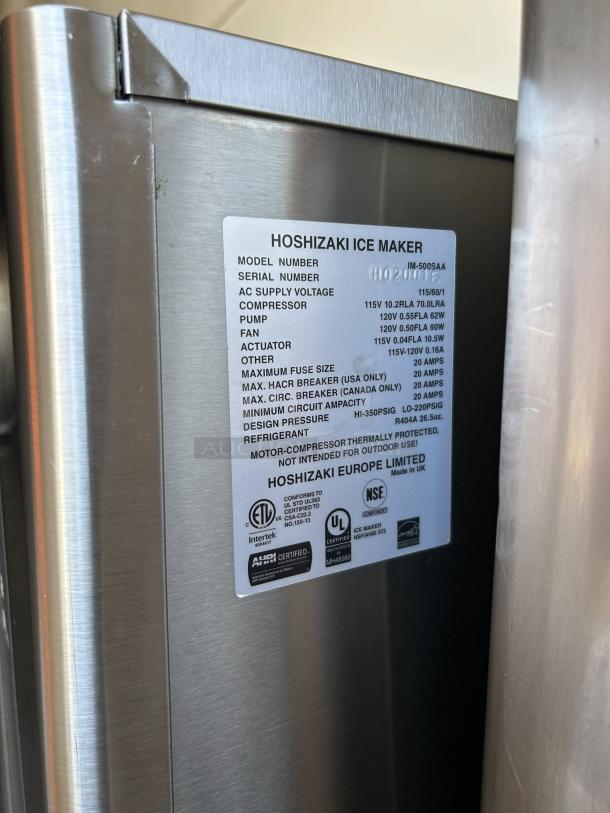 Hoshizaki IM-500SAA ice machine label showing model info, voltage, and certifications; stainless steel surface, well-maintained.