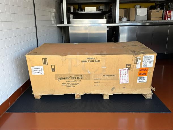 New Henny Penny HHC-900 insulated holding cabinet in box, SimpleHold controls, 120V. Box labeled fragile, with unpacking instructions.