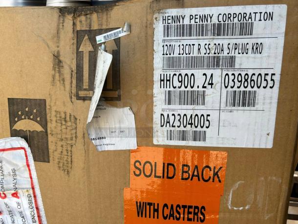 New Henny Penny HHC-900 Insulated Holding Cabinet box with labels showing model and serial numbers. 120V, with casters.