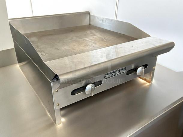 American Range ARSMG-24 24" gas griddle in great condition, featuring manual controls, stainless steel body, and tested functionality.