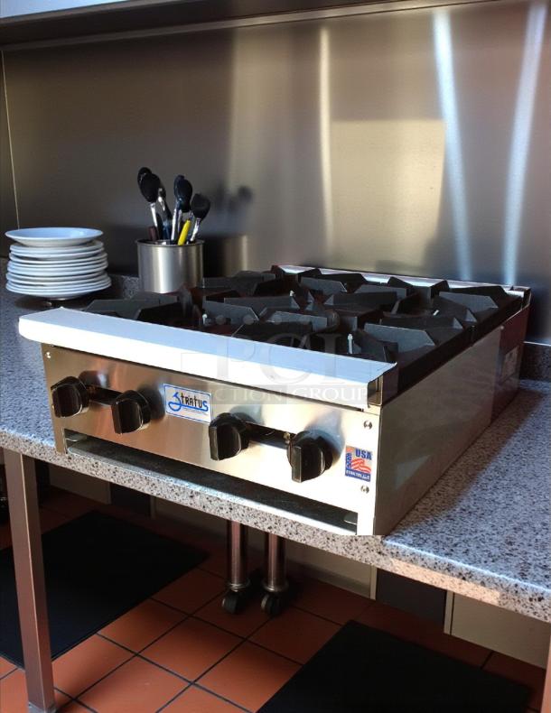 Stratus SHP-24-4 countertop 4-burner gas range on granite surface, tested and working, with control knobs and Stratus branding.