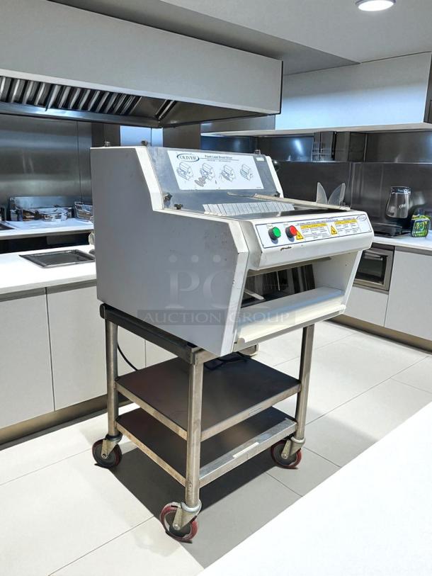 Oliver 732-N front-load bread slicer with bagging scoop, 115v. Great condition, tested and working. Features control panel and safety warnings.