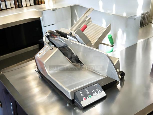 Bizerba Model L-22 meat slicer with 13" blade on stainless steel counter. Features include safety dial, aluminum body, tested working.