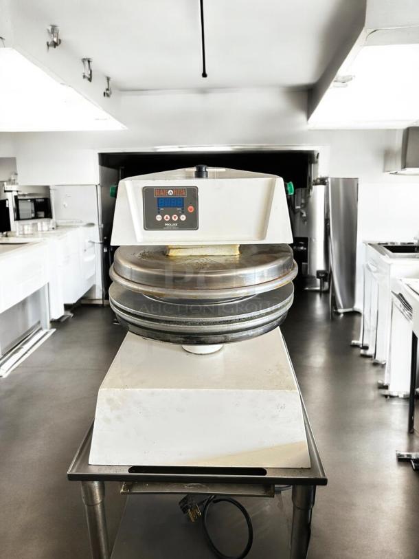Proluxe DP2350S automatic pizza dough press, 17", 208V 1PH, good condition, tested and working, features control panel.