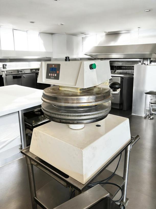Proluxe DP2350S, 17" automatic pizza dough press, tested and working, 208V, 1PH. White body, metal press plates. Good condition.