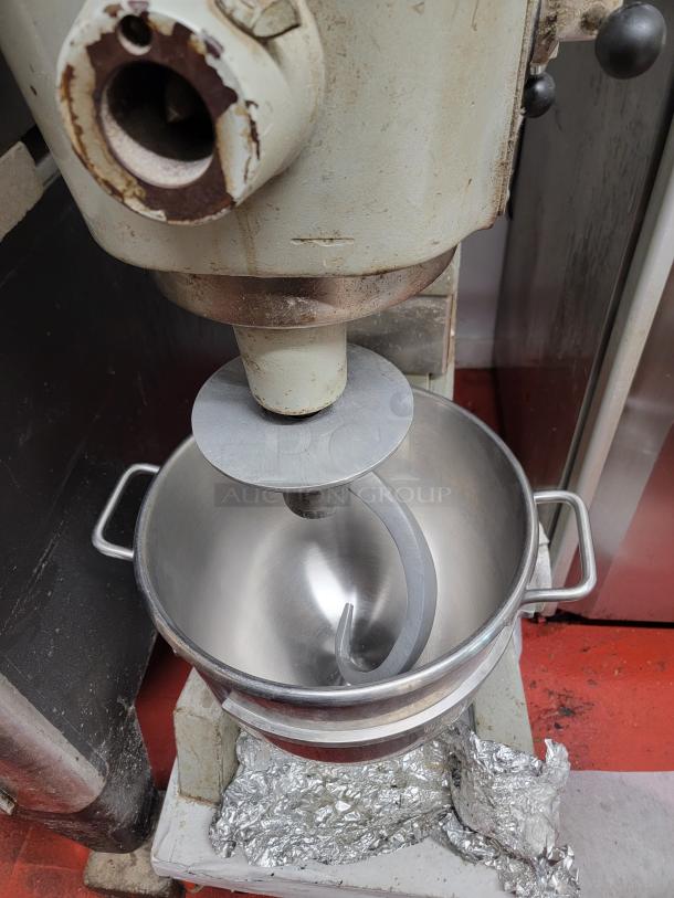 Hobart D300 30 Qt Mixer on Casters, shows wear, durable stainless steel bowl, dough hook attachment, essential for high-volume prep.