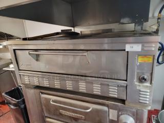 Zesto Model 212 single-deck gas pizza oven, stainless steel, durable, commercial use, with visible control panel and logo.