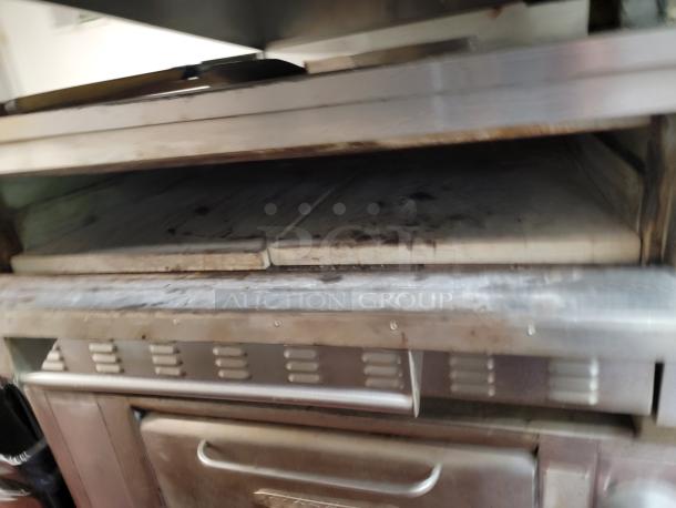 Zesto Model 212 single-deck gas pizza/bake oven, stainless steel, used condition, designed for commercial kitchen use.