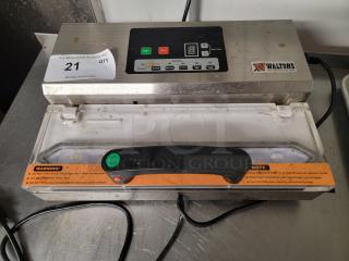 Walton's 12" Commercial Vacuum Sealer, model 1A-DS223, pre-owned. Features control panel, stainless steel build, and warning labels.