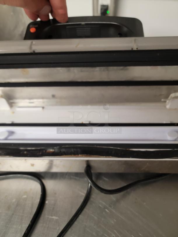 Pre-owned Walton's 12-inch commercial vacuum sealer, model 1A-DS223. Visible wear, ideal for food preservation.