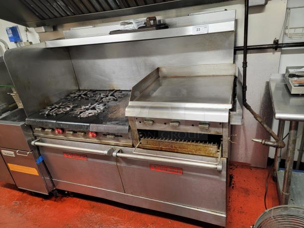 Vulcan 4-burner commercial range with 24" raised griddle/broiler and ovens, stainless steel, used condition, ideal for high-volume cooking.