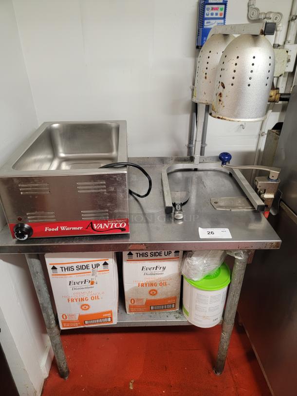 Complete hot holding station with Avantco food warmer, dual heat lamps, 3-foot stainless steel table, and EverFry oil boxes.
