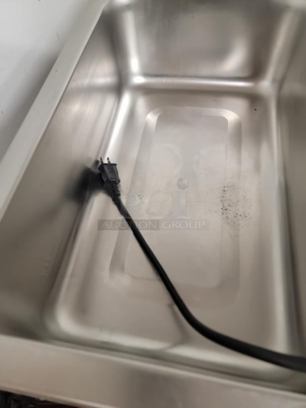Stainless steel hot holding unit with power cord, part of a versatile kitchen prep station. Includes Avantco warmer and other items.