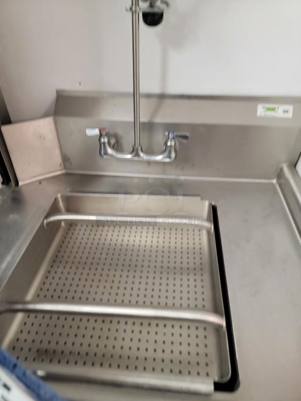Champion DH6000T Commercial Dishwasher with pre-rinse faucet, stainless steel tables, and perforated dish rack. Clean condition.