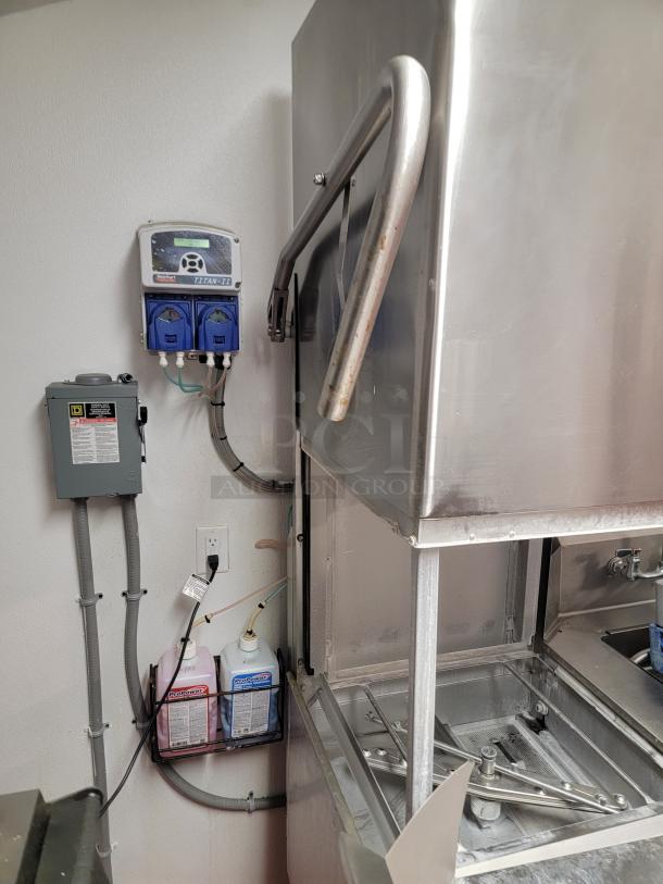 Champion DH6000T commercial hood-type dishwasher with stainless steel tables and pre-rinse faucet in clean condition.