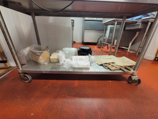 5' stainless steel work table on casters with a Nemco 5-bulb warming lamp, includes take-out supplies bundle.