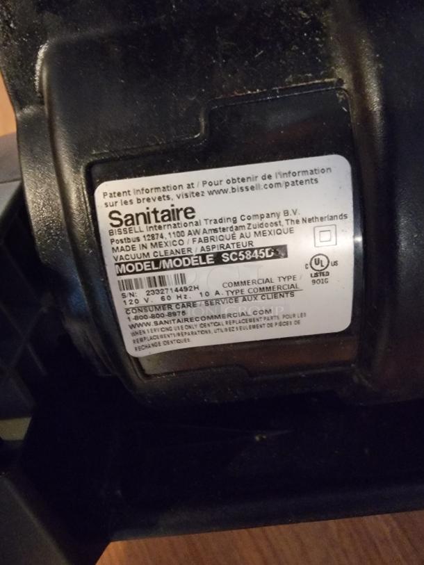 Label on Sanitaire vacuum cleaner, model SC5845D, by Bissell. Indicates commercial type, 120V, made in Mexico.