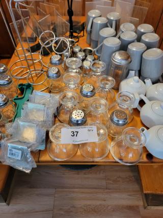 Huge lot of assorted commercial kitchen supplies including mugs, teapots, salt shakers, racks, and wall art. Condition: good.