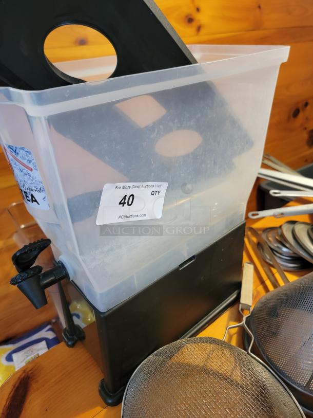 Huge lot of assorted commercial kitchen supplies and utensils, including a beverage dispenser, strainers, and various tools. Auction tag indicates "40 QTY."