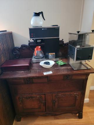 Antique 44" dry bar with carved wood details, holding Bunn coffee makers and accessories. Ideal for home or business use.