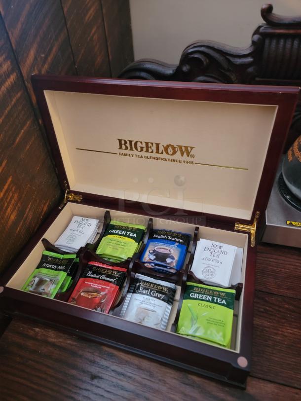 Wooden Bigelow tea box with eight assorted tea packets, featuring flavors like Earl Grey and Green Tea. Perfect for home or business.