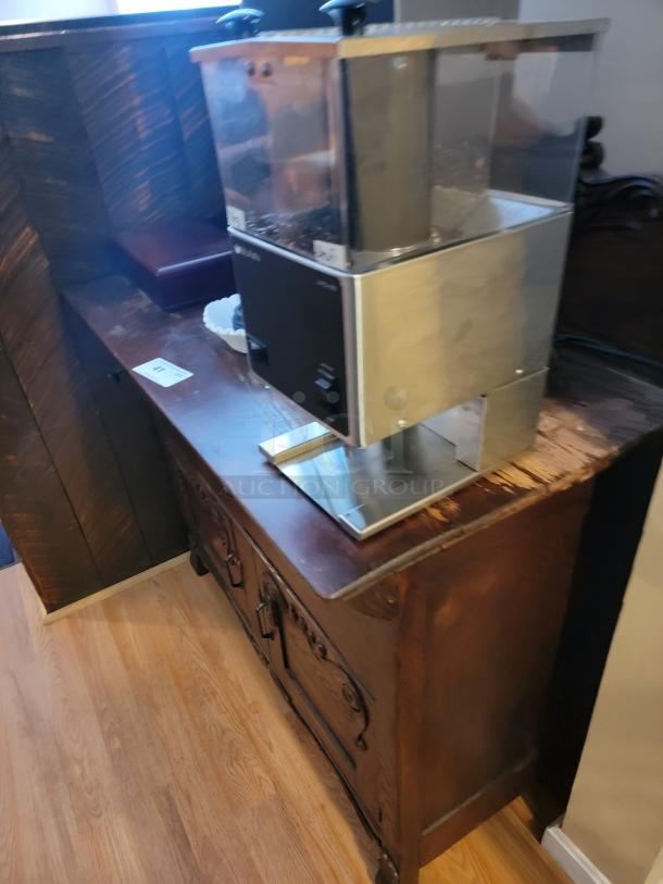 Antique 44" dry bar with ornate wood design, paired with a commercial stainless steel coffee grinder. Ideal for home or business setup.
