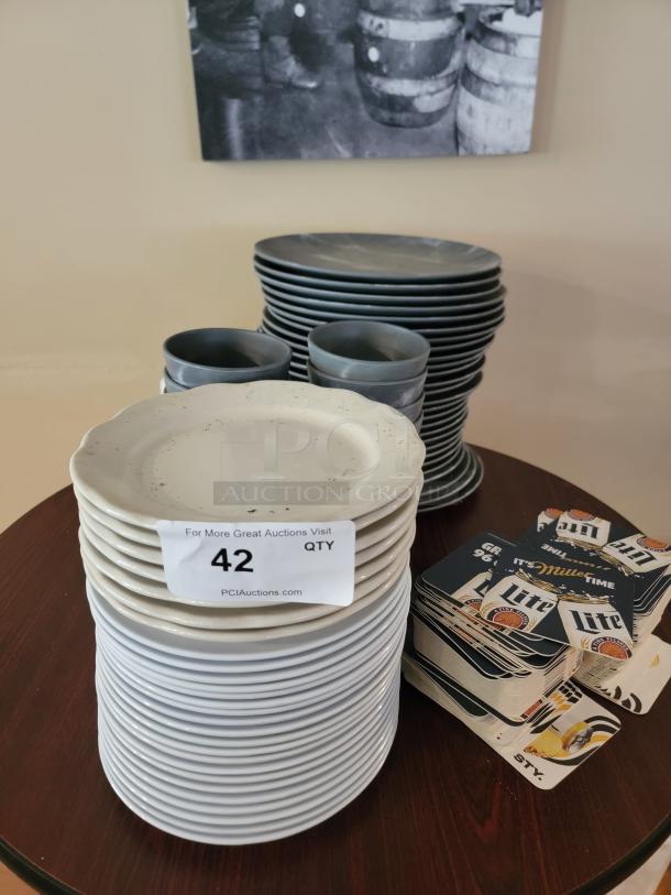 Commercial-grade dinnerware set with stacked plates, bowls, and Miller Lite coasters. Includes auction label with lot number.