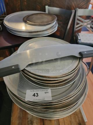 Lot of commercial pizza pans, screens, rack, and rocker cutter. Includes perforated, solid pans. Label reads "Qty 43."