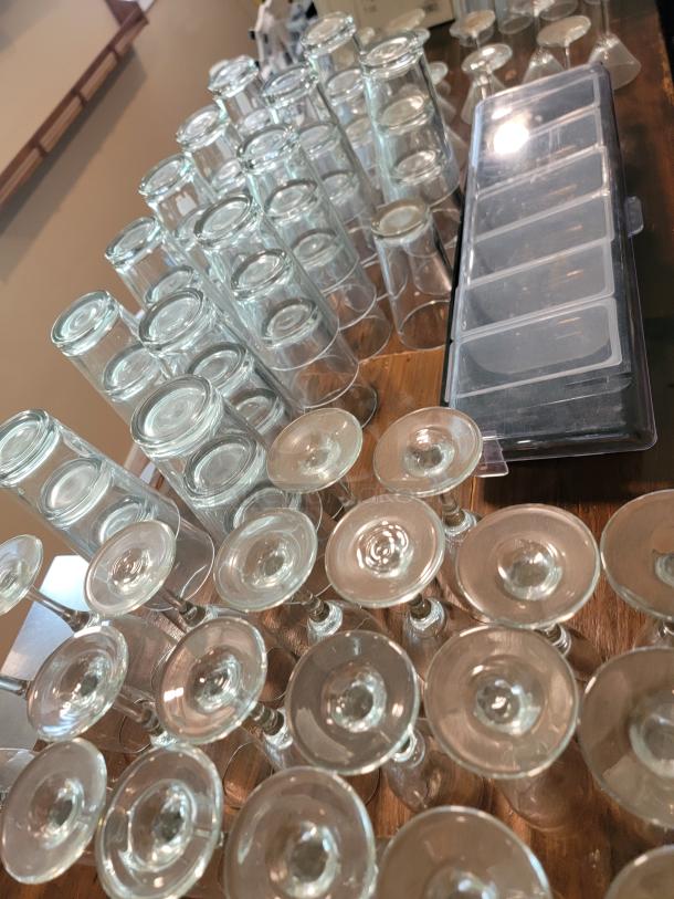 Massive lot of commercial-grade glassware, includes various types of clean glasses for bars, restaurants, or events.