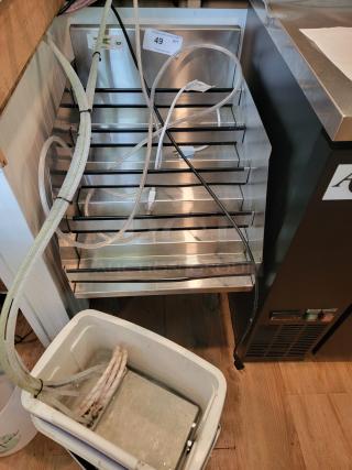 Regency Stainless Steel 5-Tier Liquor Bottle Display Rack, Model 600LDR2318, showing its durable structure and NSF certification tag.