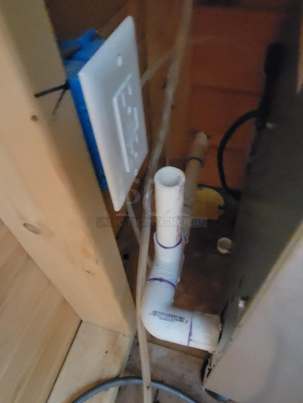 Scotsman CU0715MA-1A undercounter ice machine, plumbing connections visible, ideal for consistent ice production.