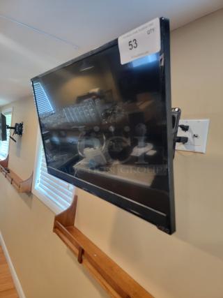 Wall-mounted Vizio TV, model E280B1, in used condition with visible numbering tag. Includes mounting hardware.