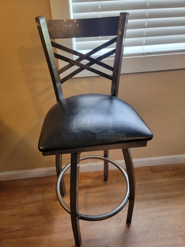 Lancaster swivel bar stool in steel gray gloss finish, black cushioned seat, crisscross back design, ideal for modern settings.
