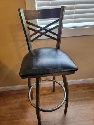 Lancaster swivel bar stool in steel gray gloss finish, black cushioned seat, crisscross back design, ideal for modern settings.