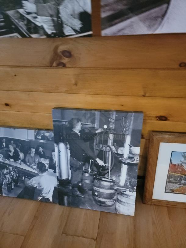 Black and white historical and scenic landscape wall art collection, featuring multiple framed and unframed pieces displayed on a wooden floor.