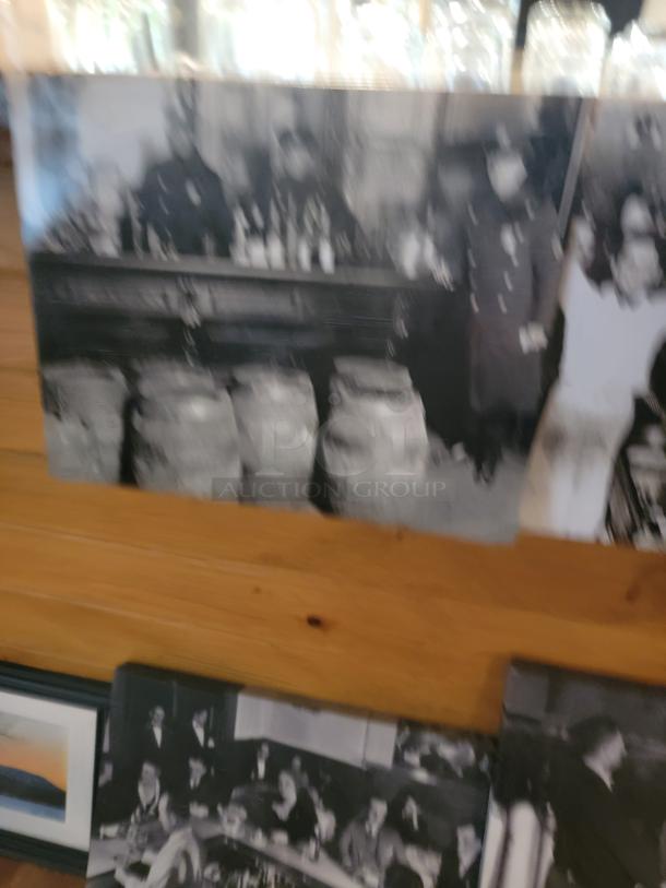 Unique wall art collection featuring black and white historical scenes and scenic landscapes. Mix of framed and unframed pieces.