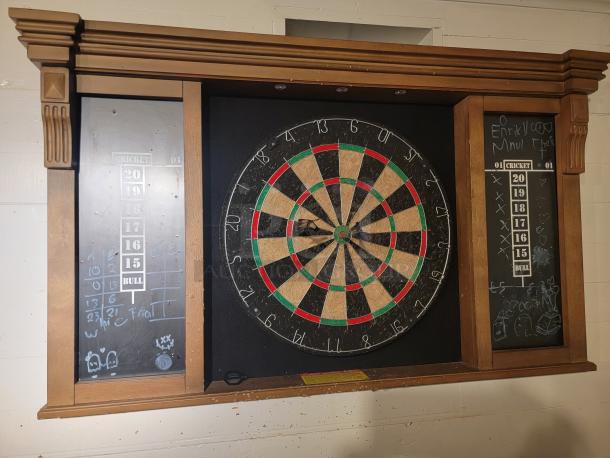 MD Sports DRB100 wall mount dart board cabinet set with battery-powered lighting, visible wear on dart board, chalk scoreboards.
