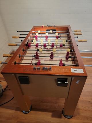Classic Sport Foosball table, wooden frame, steel rods, ergonomic handles, in good condition, auction tag visible.