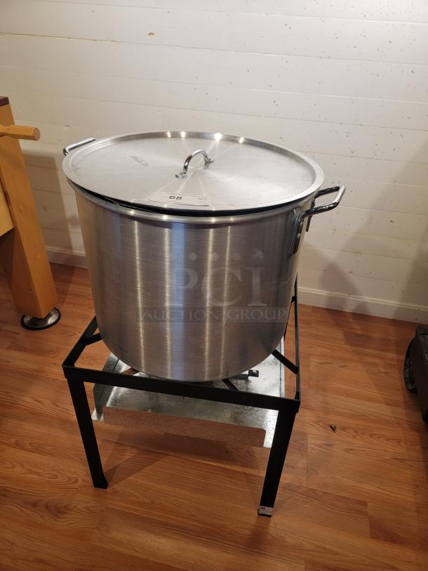 Backyard Pro 80 Qt Aluminum Outdoor Propane Broiler/Steamer with lid on black stand, in good condition.