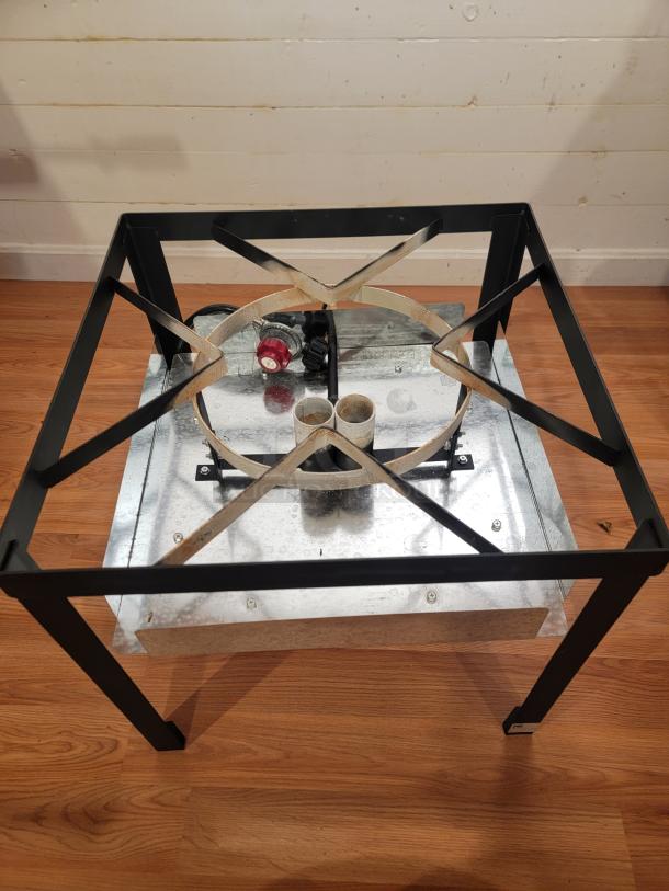 Backyard Pro 80 Qt Aluminum Outdoor Propane Broiler/Steamer frame, black metal, new condition, gas inlet visible.