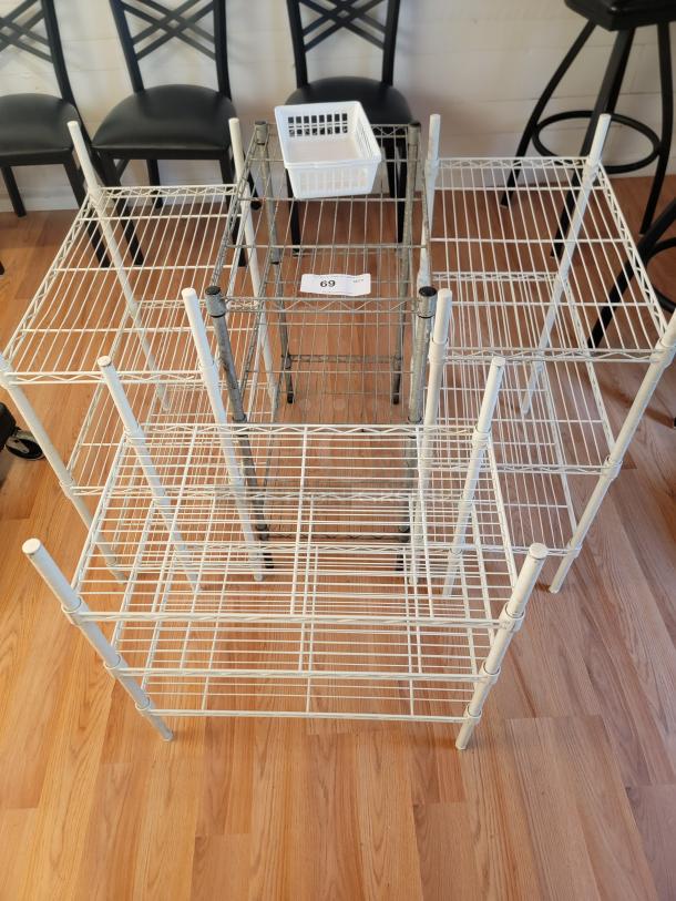 Four assorted metal racks, 24"x31", showing white and gray finishes, moderate wear, tag marked "69."