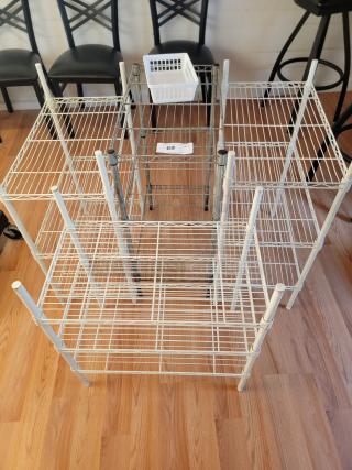 Four assorted metal racks, 24"x31", showing white and gray finishes, moderate wear, tag marked "69."
