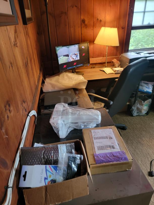 Office clearance items including a desk, chair, monitor, lamp, printer, and boxed supplies. Buyer to remove all.