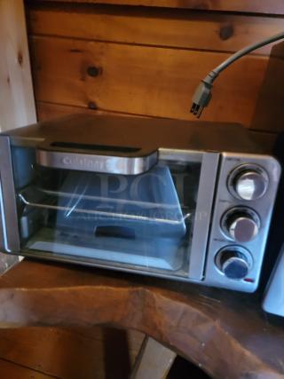 Cuisinart toaster oven in used condition, featuring three dials and visible power cord, suitable for kitchen or business use.