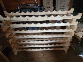 Natural wooden wine rack with multiple shelves, ideal for wine storage and display. Classic design, perfect for cellars or retail.