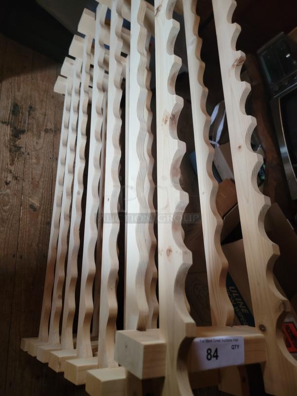 Natural wood wine rack, elegant design for cellars or displays. Excellent condition. Label shows quantity: 84.