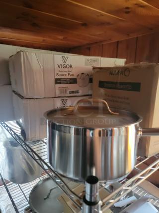 Massive commercial kitchen supply lot including Vigor 6-quart stainless steel sauce pans, Metro rack, and Acopa stoneware accessories.