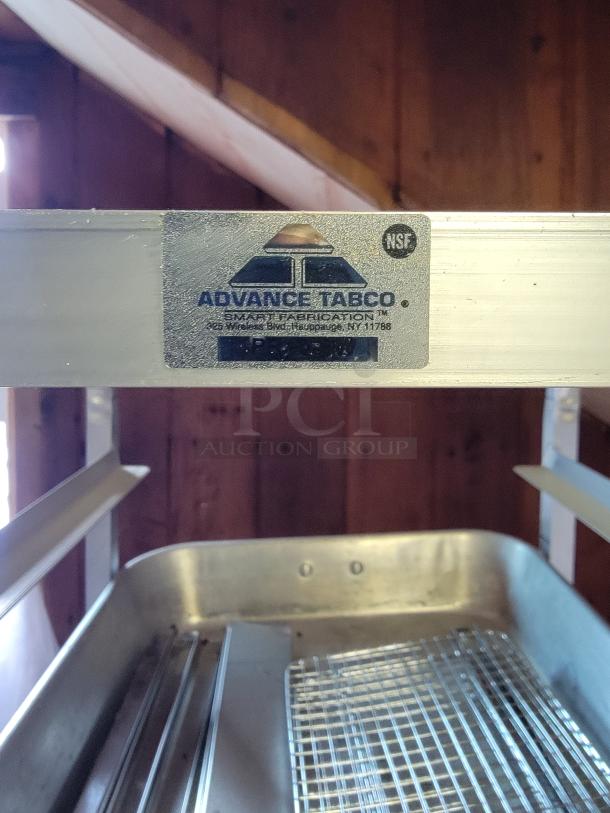 Advance Tabco Commercial Sheet Pan Rack, metal construction, on casters. Ideal for professional kitchens. Label visible with brand details.