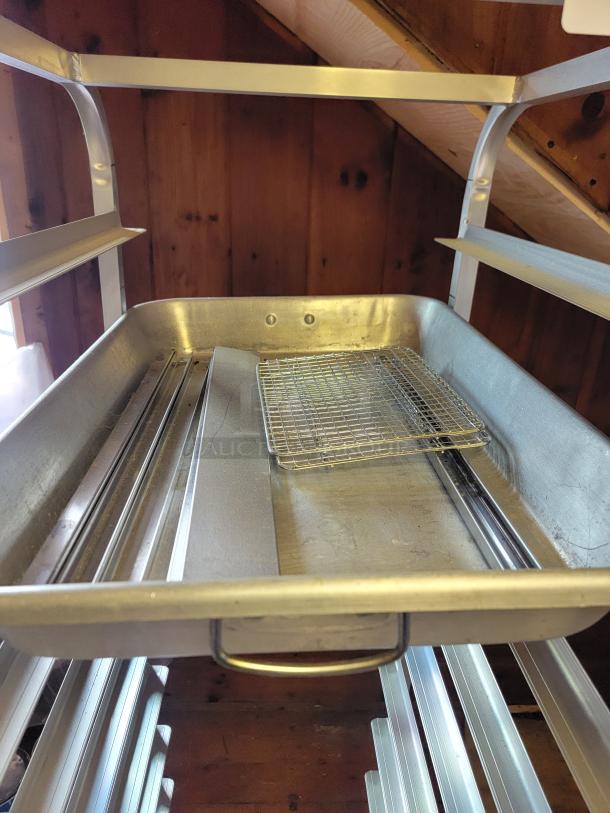 Advance Tabco commercial sheet pan rack on casters, metal, holds multiple pans, mobile, sturdy, professional kitchen use.