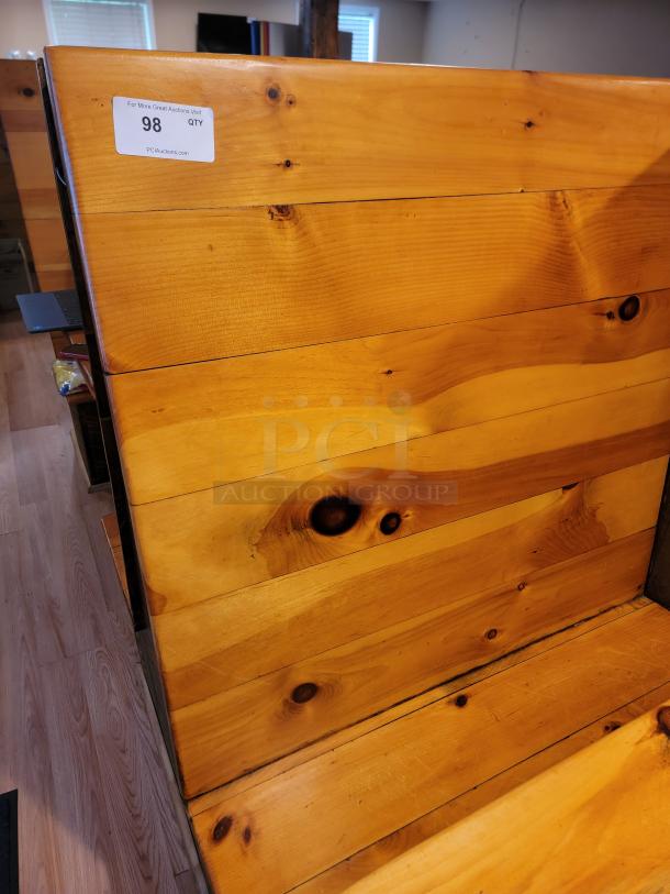 Rustic wooden restaurant booth with visible grain and knots, labeled "98 QTY" for auction details. Ideal for cozy dining spaces.